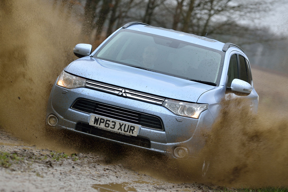 Mitsubishi Outlander PHEV driving through mud
