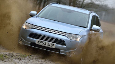 Mitsubishi Outlander PHEV driving through mud