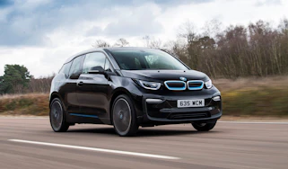 BMW i3 driving along road