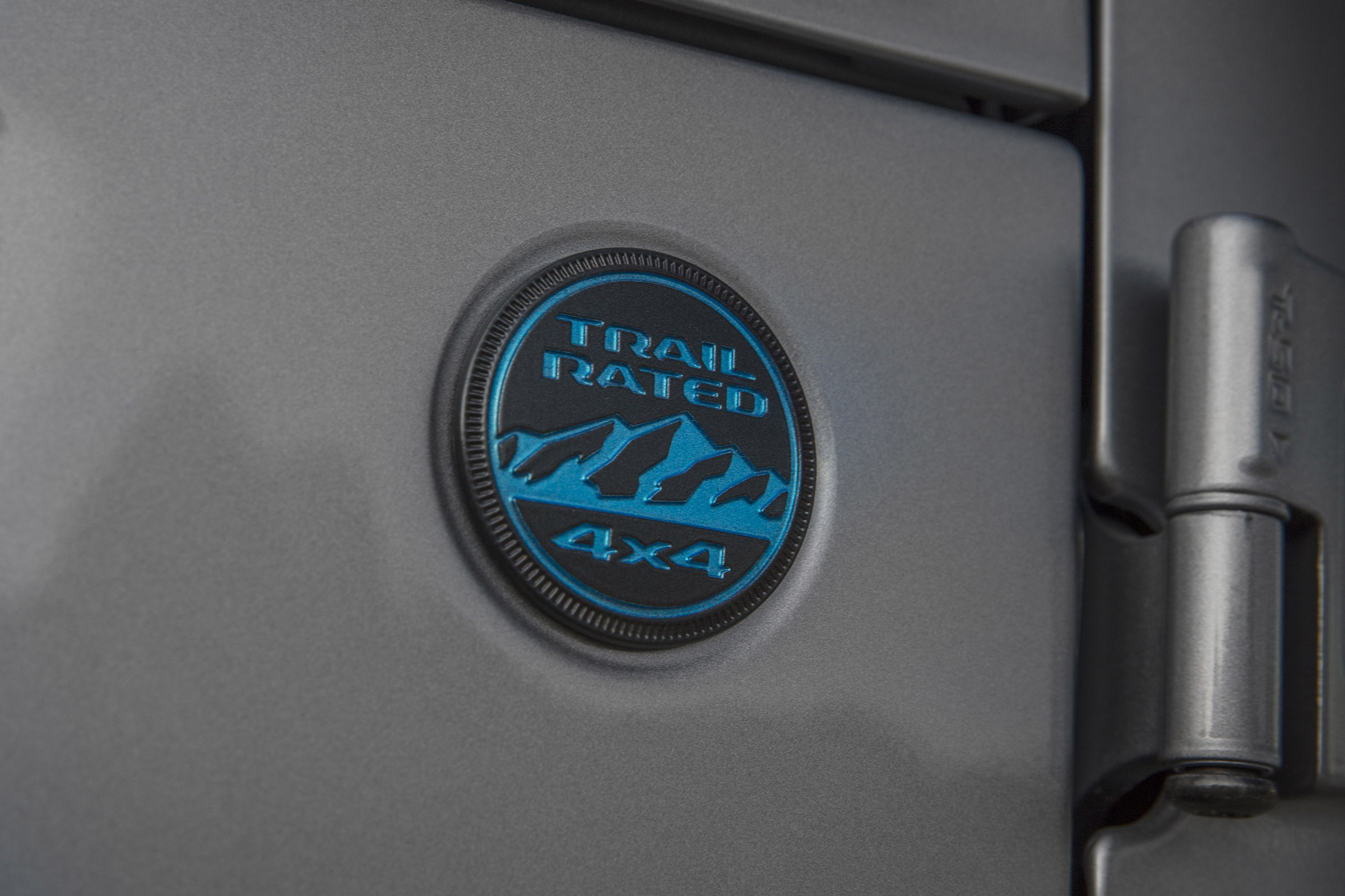 Surf Blue coloring on the Trail Rated badge denotes the 4xe version of the 2021 Jeep® Wrangler.
