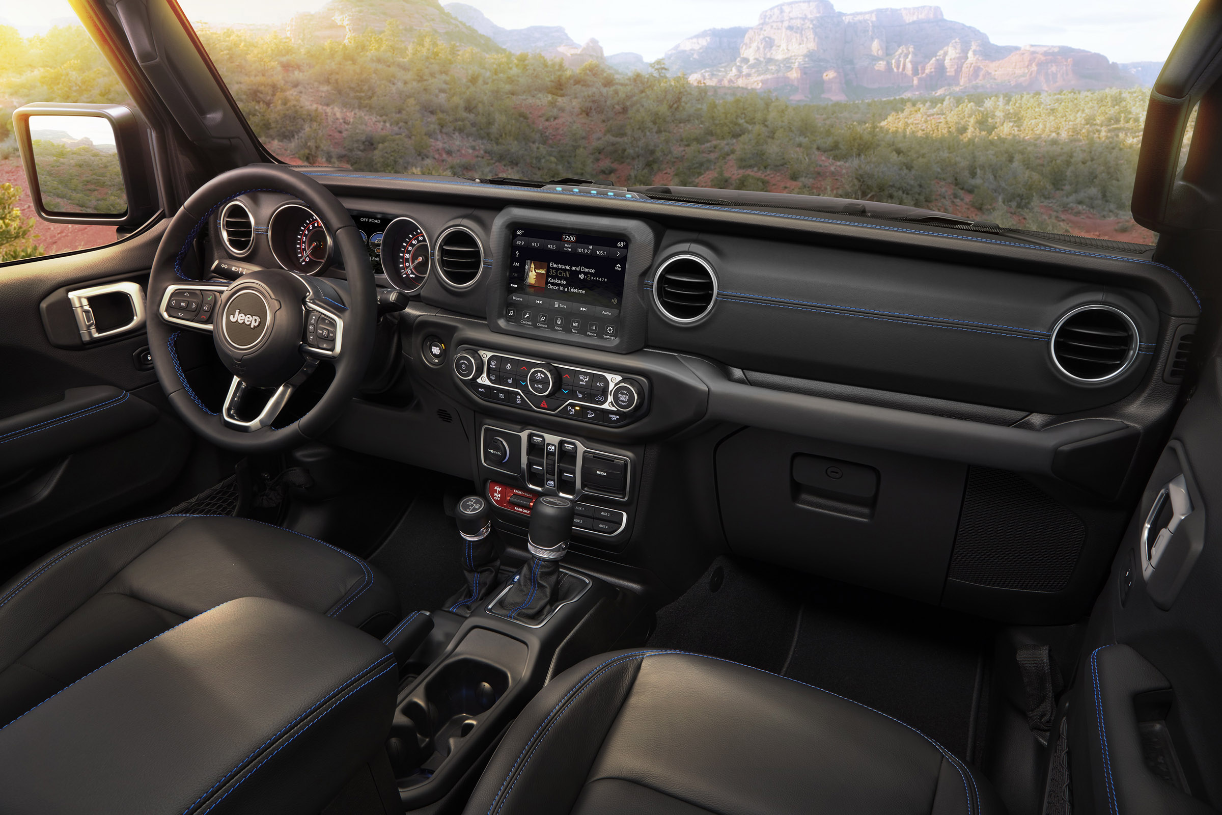 Interior of the 2021 Jeep® Wrangler Rubicon 4xe includes Surf Blue accent stitching on seats and interior trim.