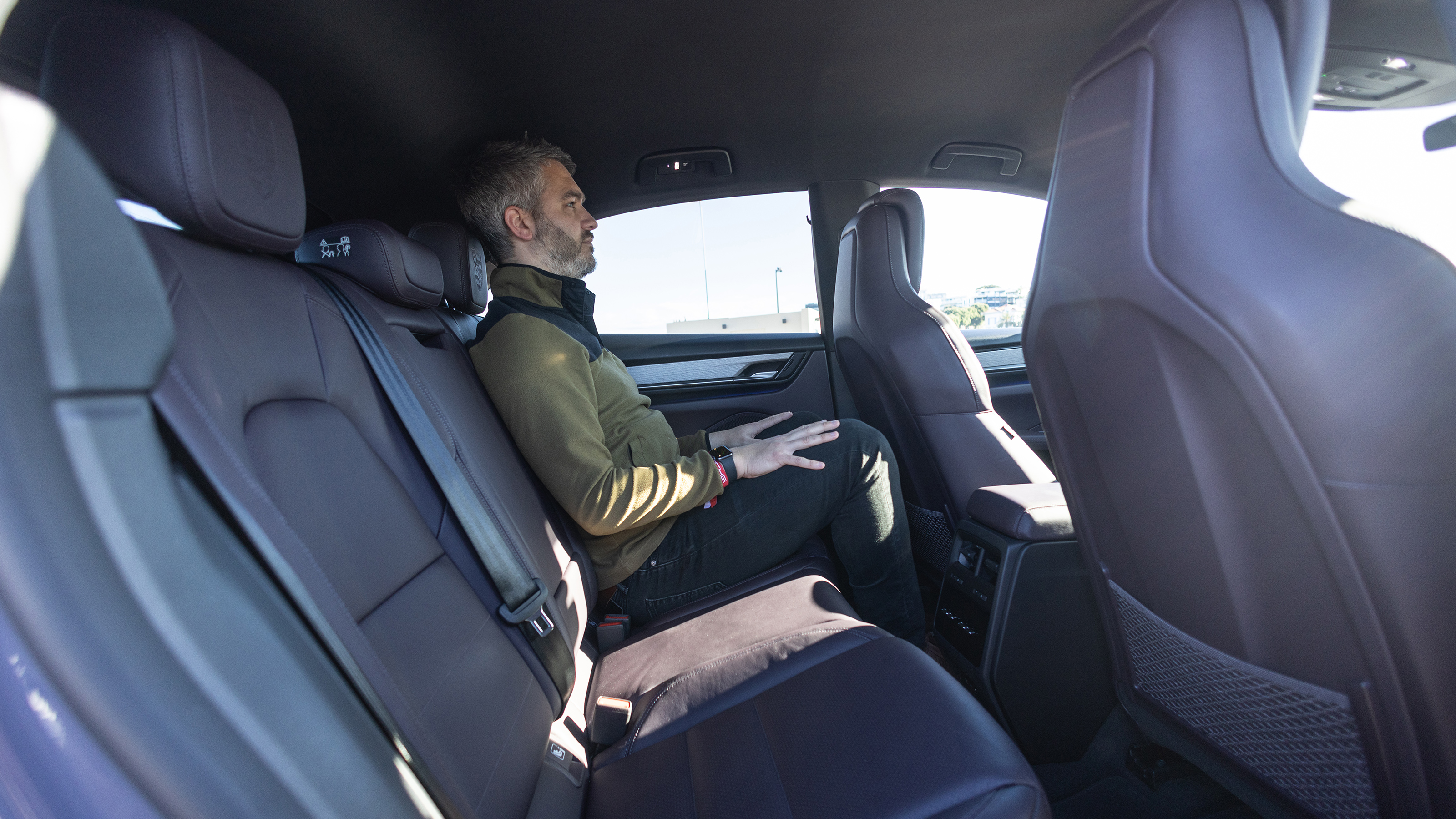 Richard Ingram sitting in the Porsche Macan's back seat