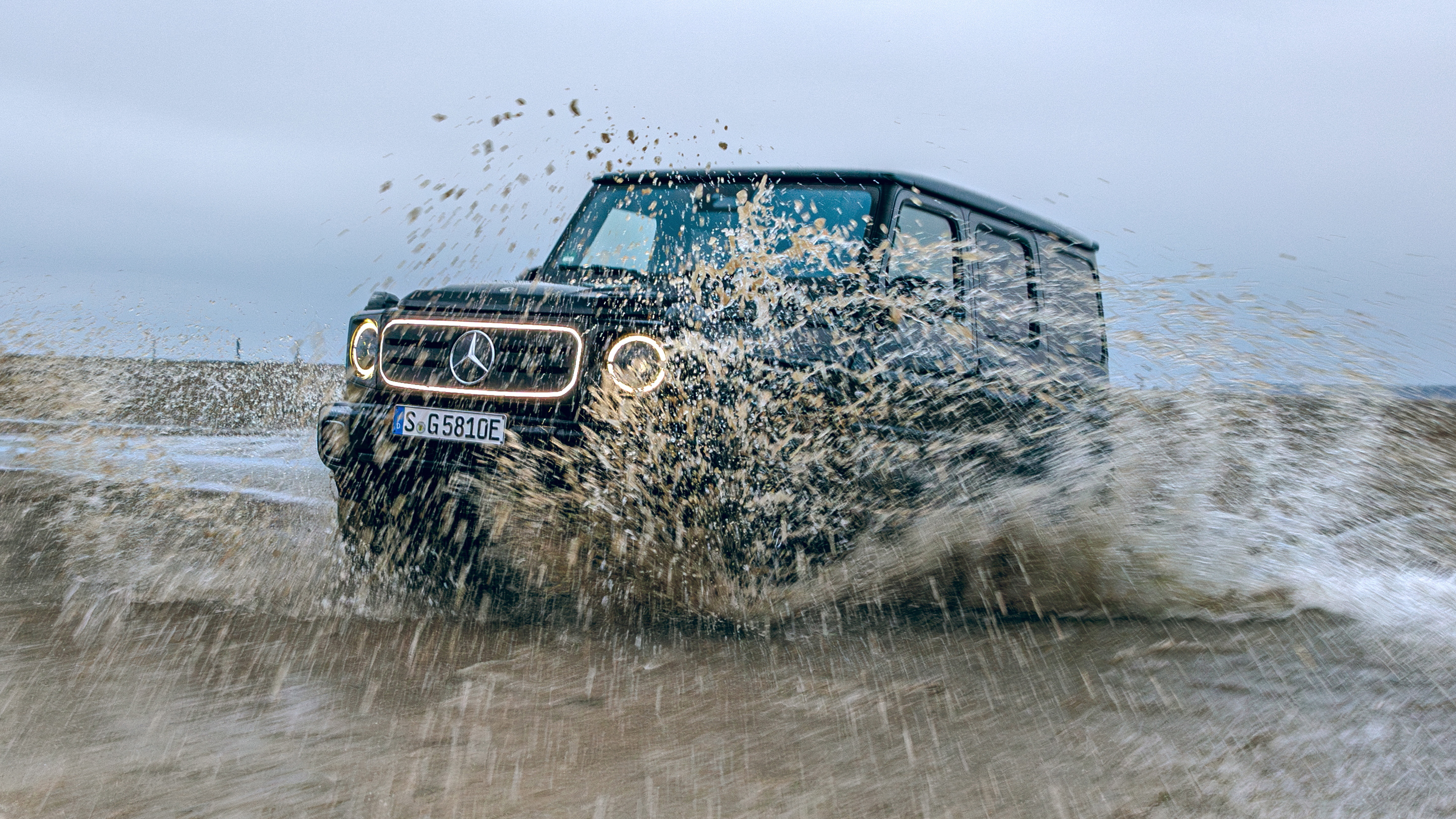 Mercedes G 580 driving through muddy water