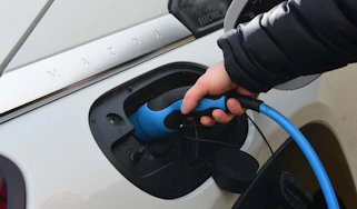 plugging in electric car charger