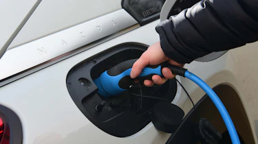 plugging in electric car charger